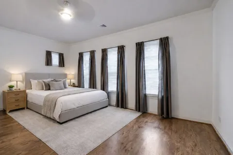 a bedroom with a large bed and a large window