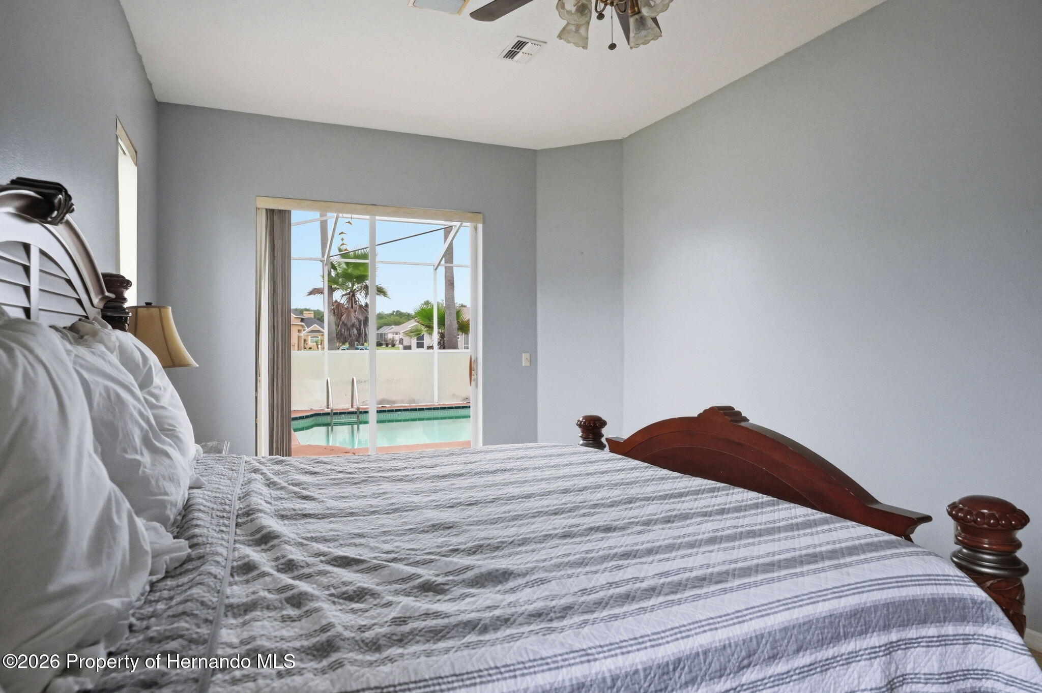 18131 Rivard Boulevard Brooksville, FL 34604 - Photo 27 of 66 a bedroom with a large bed and a window
