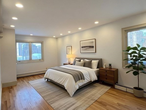 1002 Beacon Street Brookline, MA 02446 - Photo 14 of 17 a spacious bedroom with a large bed and a potted plant