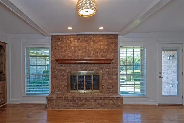 an entryway with fireplace and wooden floor