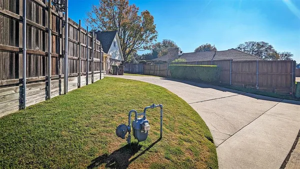 a view of backyard with wooden fence
