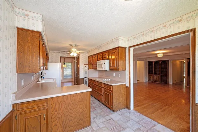 a kitchen with stainless steel appliances granite countertop a sink and cabinets