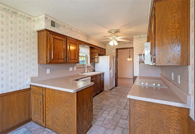 a kitchen with a sink appliances and cabinets