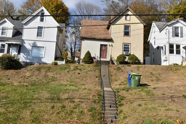 a view of a white house with large windows