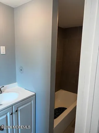 a bathroom with a toilet a sink and a window