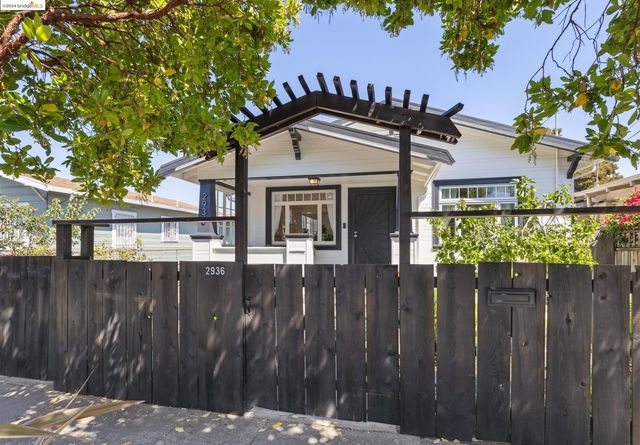 a view of a wooden house with a large trees