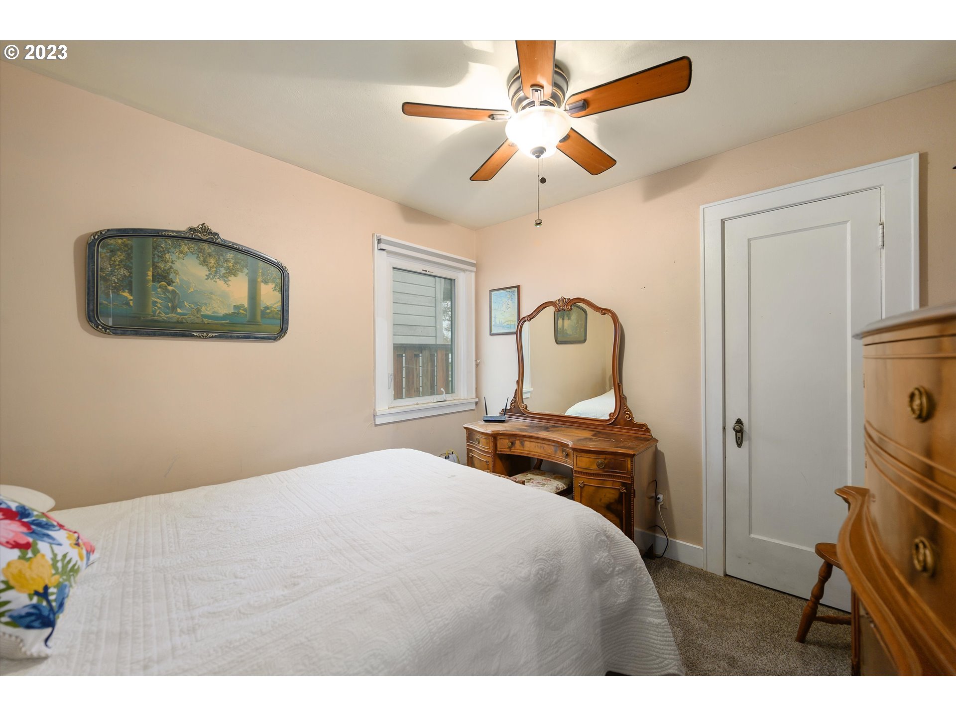 553 Southwest Clay Street Dallas, OR 97338 - Photo 20 of 33 a bedroom with a bed and a chandelier
