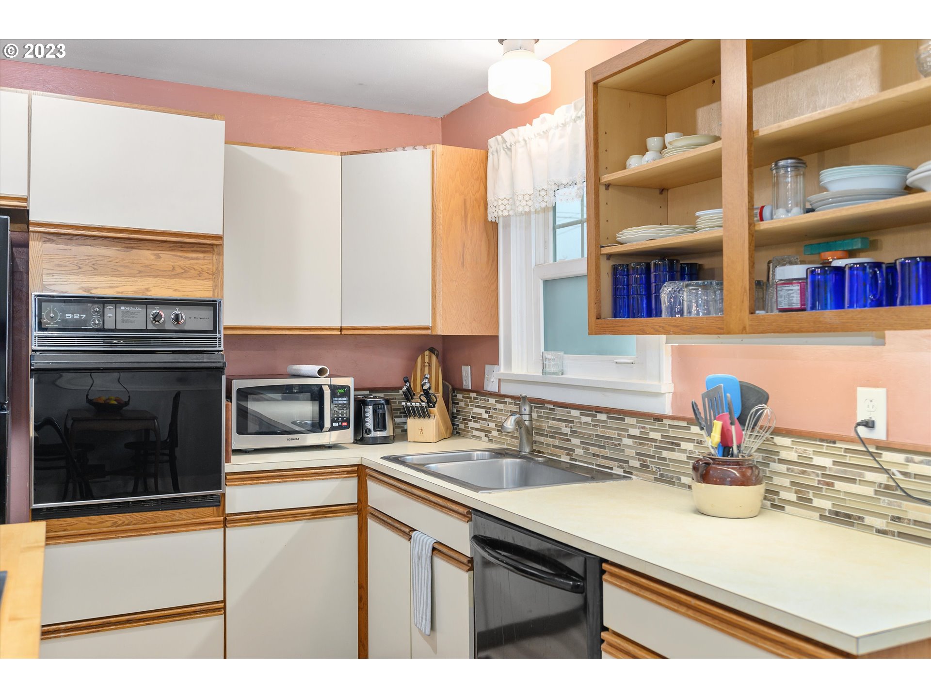 553 Southwest Clay Street Dallas, OR 97338 - Photo 9 of 33 a kitchen with a sink and a refrigerator