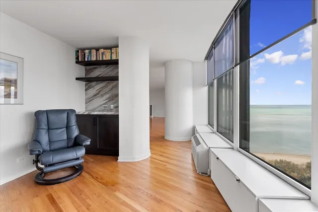 a living room with furniture and a floor to ceiling window
