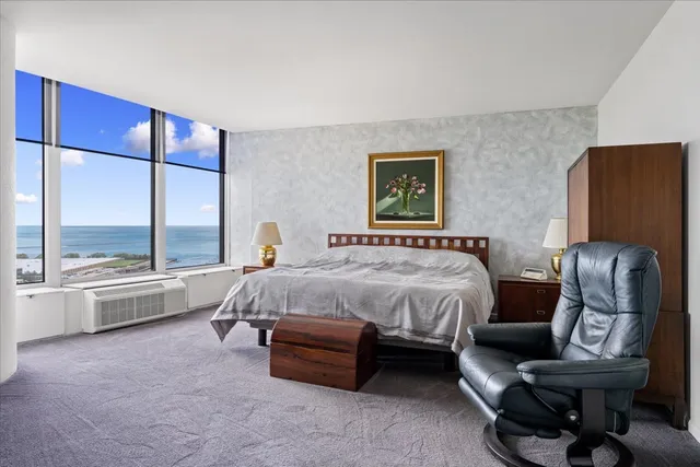 a spacious bedroom with a bed and large window