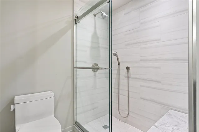 a bathroom with a toilet and shower