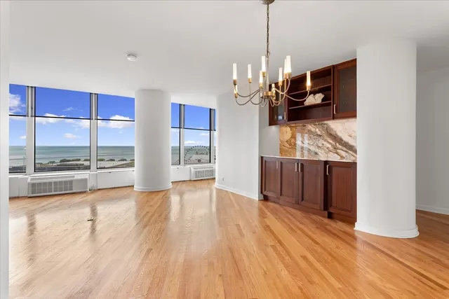 a view of a room wooden floor and windows