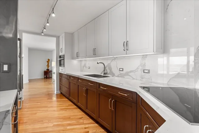 a kitchen with kitchen island granite countertop a sink window and stainless steel appliances