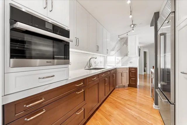 a kitchen with stainless steel appliances a refrigerator and a stove top oven