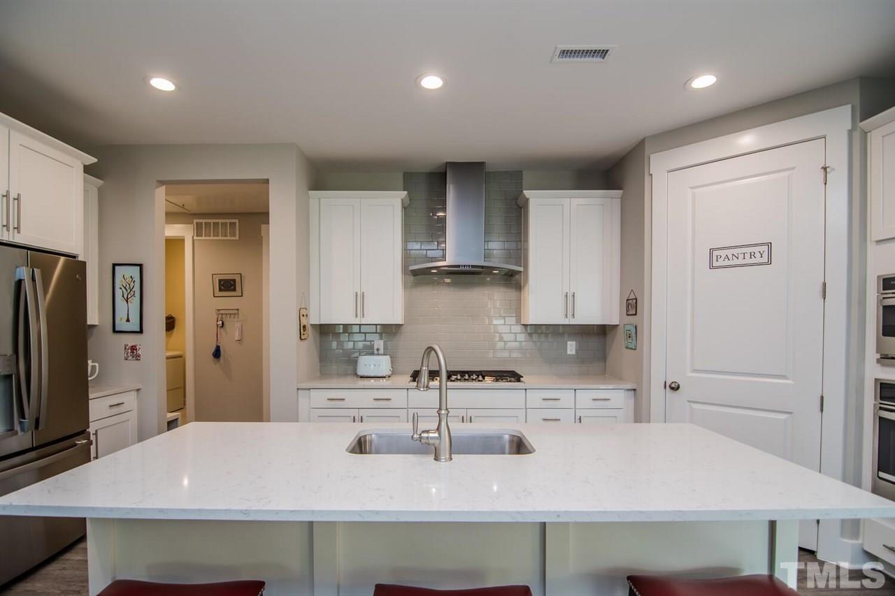 1210 Pondfield Way Durham, NC 27713 - Photo 15 of 29 a kitchen with kitchen island a sink stainless steel appliances and cabinets