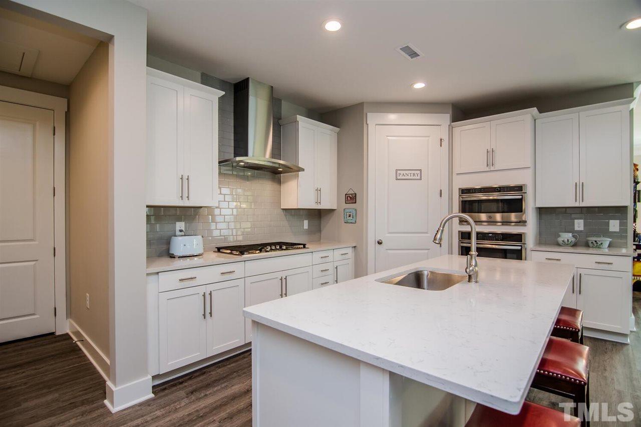 1210 Pondfield Way Durham, NC 27713 - Photo 16 of 29 a kitchen with stainless steel appliances granite countertop a stove refrigerator sink and cabinets