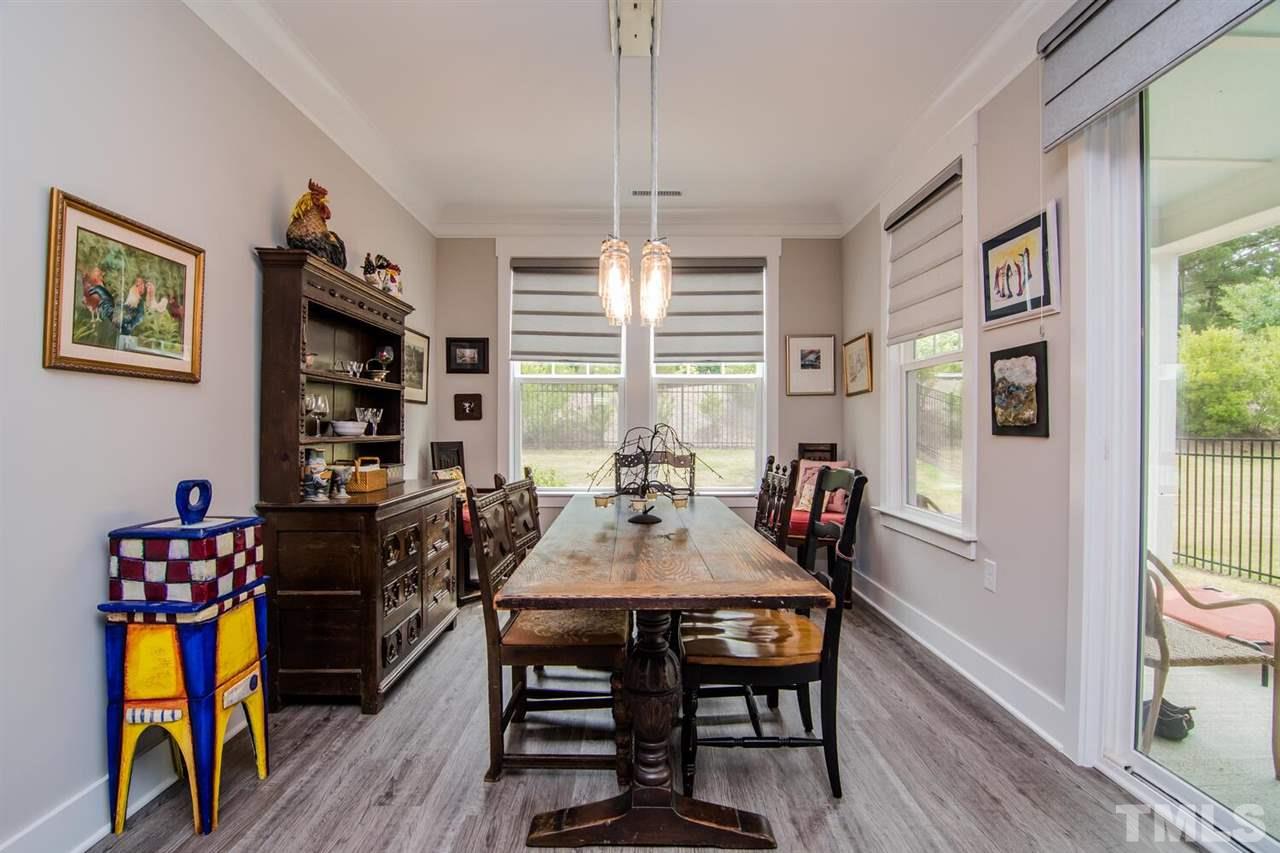 1210 Pondfield Way Durham, NC 27713 - Photo 19 of 29 a dining room with furniture and wooden floor
