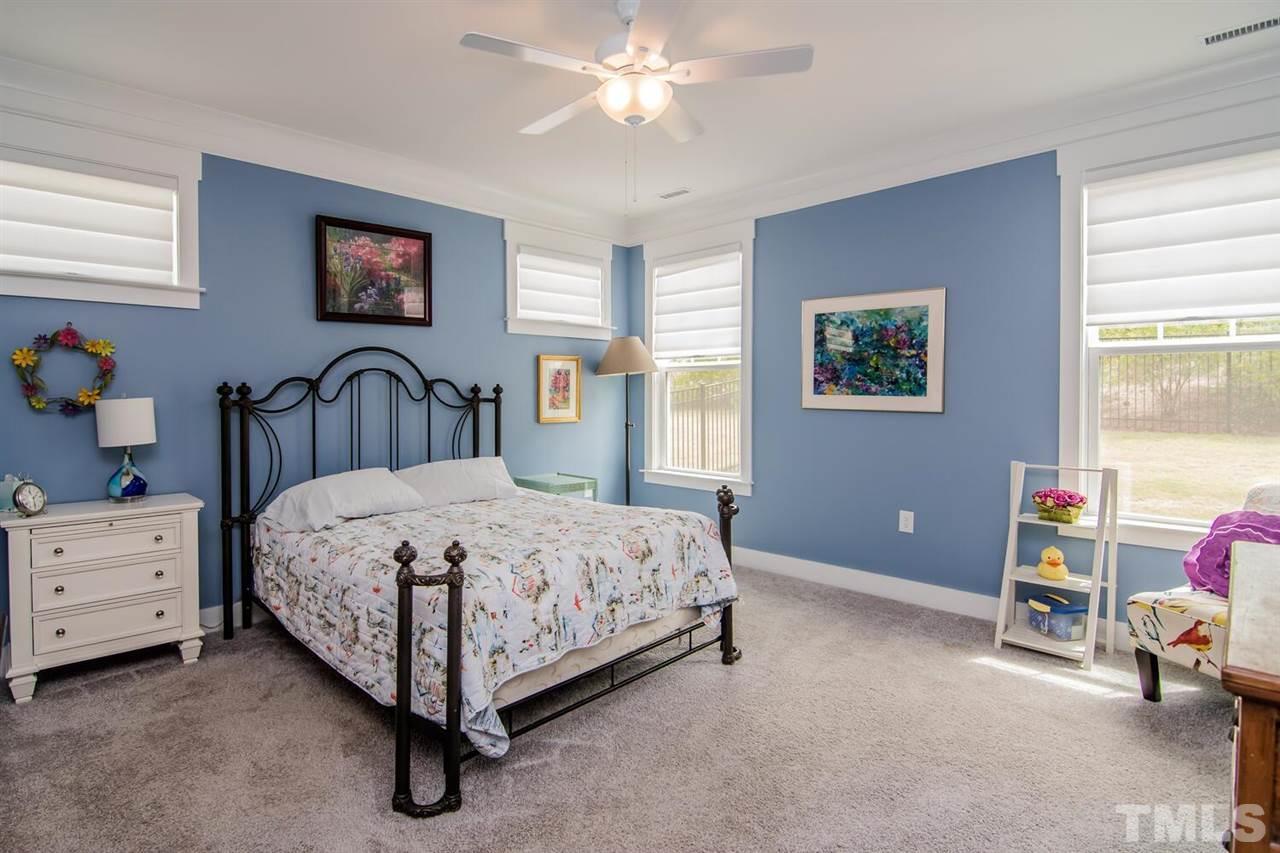 1210 Pondfield Way Durham, NC 27713 - Photo 20 of 29 a spacious bedroom with a bed and a dresser