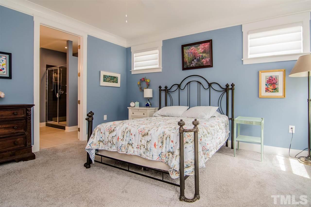 1210 Pondfield Way Durham, NC 27713 - Photo 21 of 29 a bedroom with a bed and a table