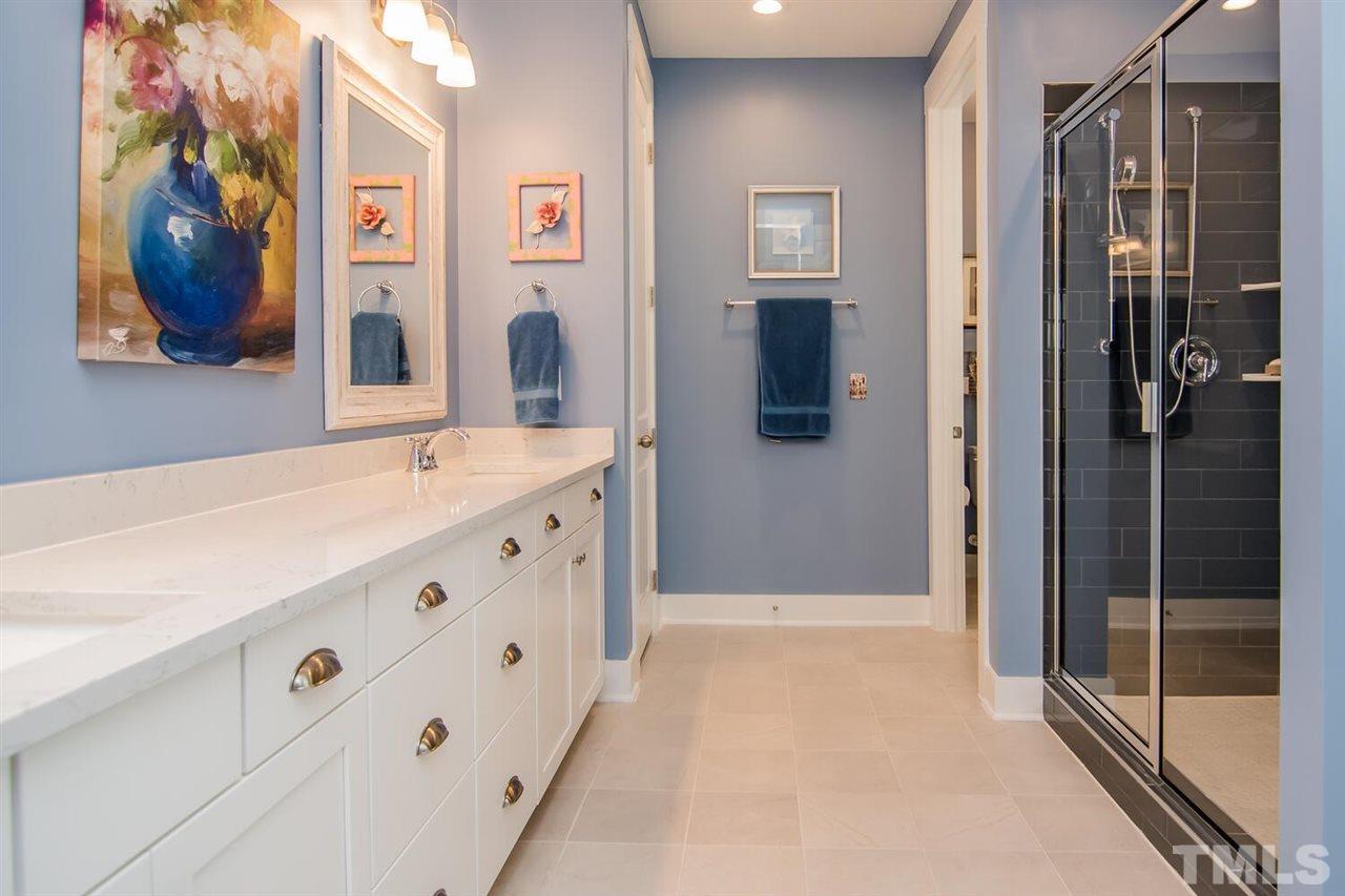 1210 Pondfield Way Durham, NC 27713 - Photo 22 of 29 a bathroom with a tub sink and mirror