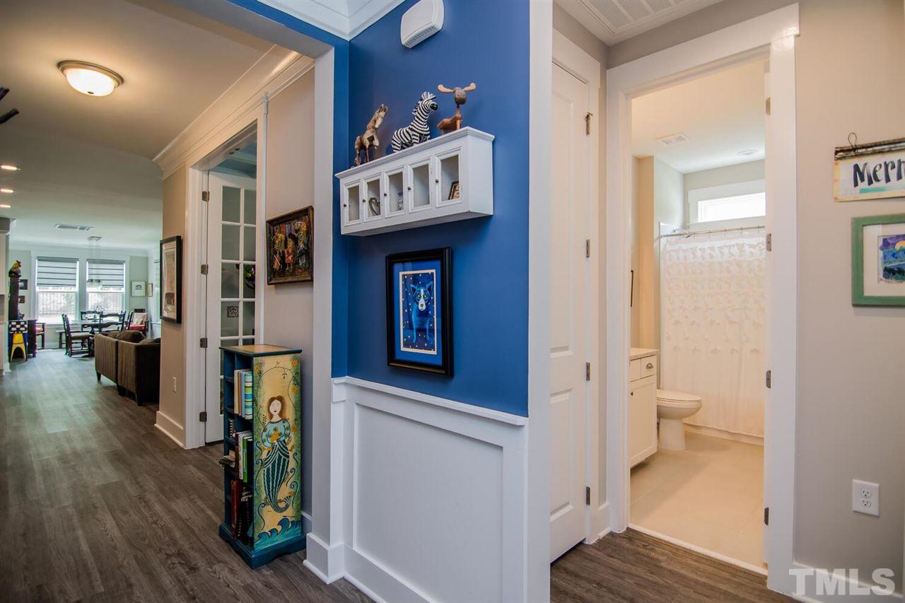 1210 Pondfield Way Durham, NC 27713 - Photo 4 of 29 a view of a hallway with wooden floor and a living room