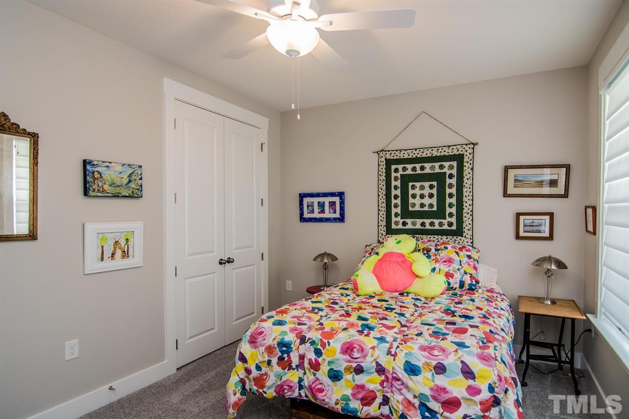 1210 Pondfield Way Durham, NC 27713 - Photo 8 of 29 a bedroom with a bed and wooden floor