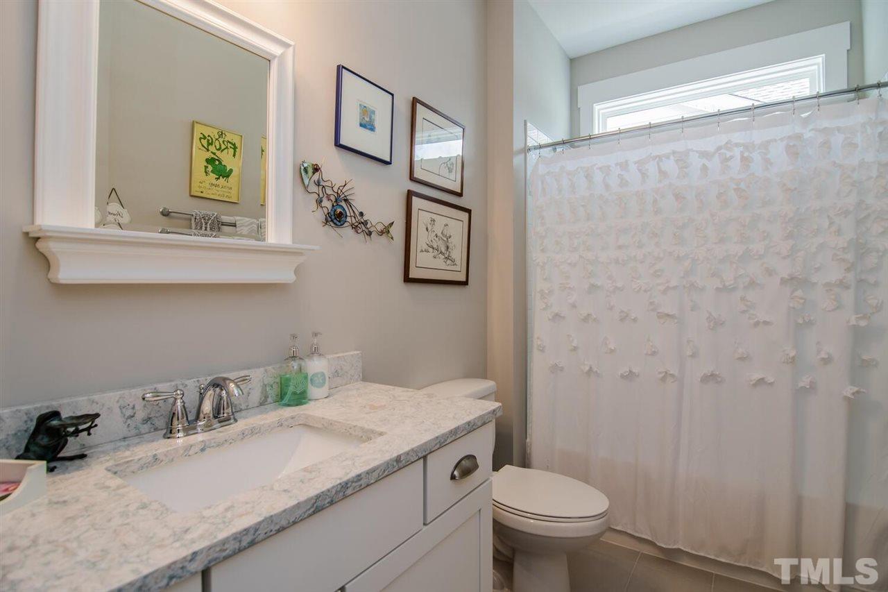 1210 Pondfield Way Durham, NC 27713 - Photo 9 of 29 a bathroom with a granite countertop sink and a toilet