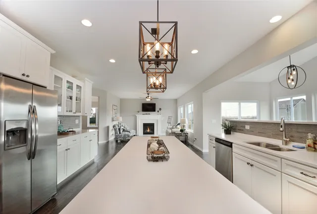 a kitchen with stainless steel appliances a refrigerator sink and cabinets