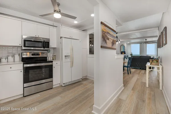 a kitchen with a sink stainless steel appliances and cabinets