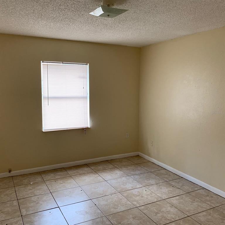 518 Pinewood Avenue Lakeland, FL 33815 - Photo 4 of 5 a view of a small space with wooden floor and a window