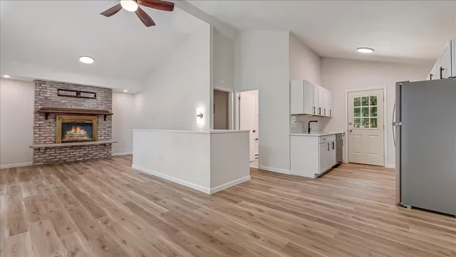 a view of an empty room with wooden floor