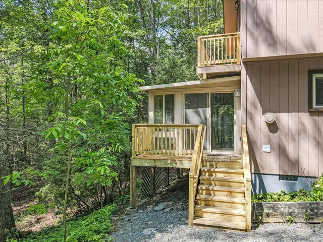 a view of a house with wooden fence