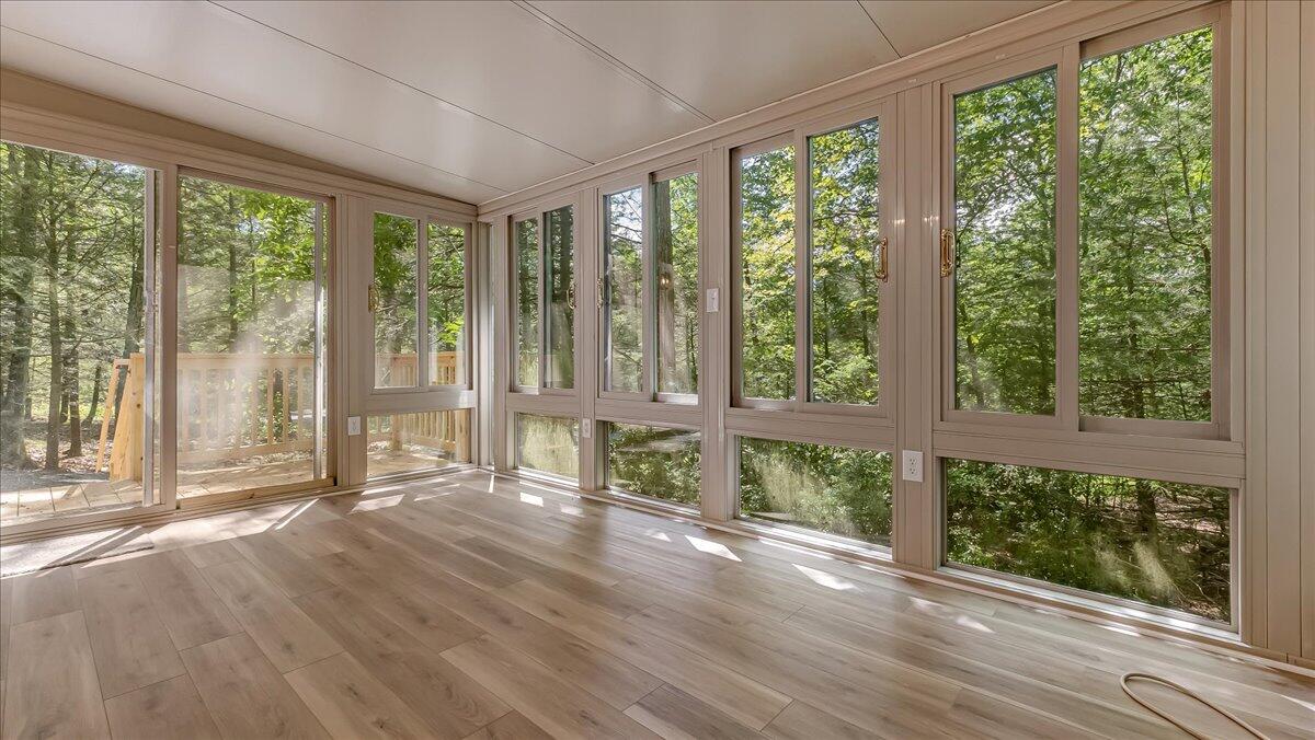 169 Sportsmen Drive Cresco, PA 18326 - Photo 6 of 61 a view of an empty room with wooden floor and a large window