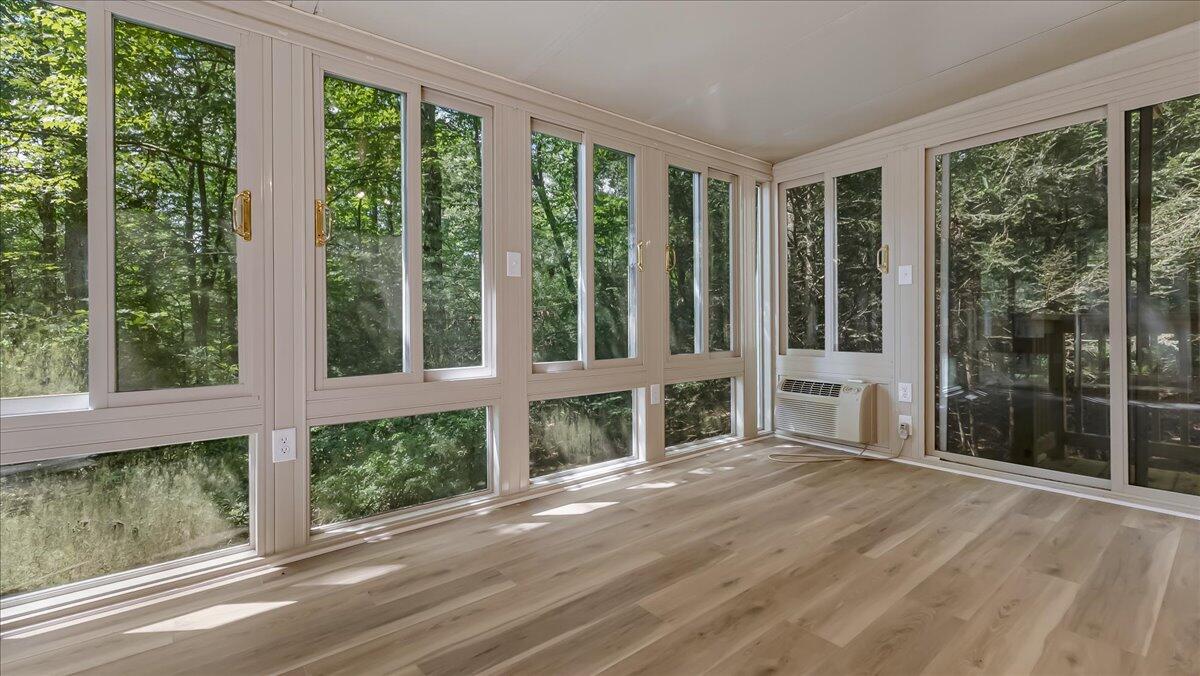 169 Sportsmen Drive Cresco, PA 18326 - Photo 7 of 61 a view of an empty room with wooden floor and outdoor view
