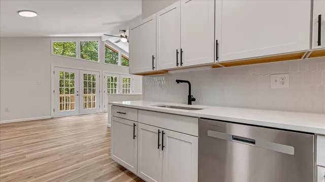 a kitchen with a sink cabinets and a window