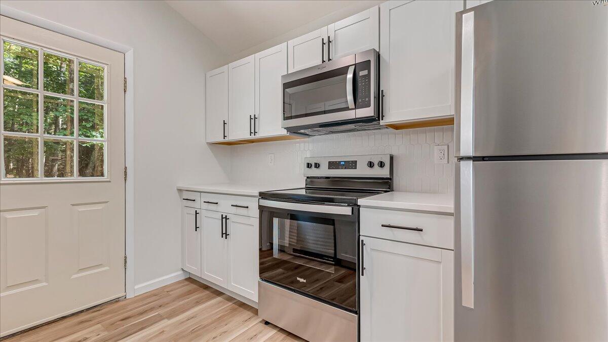 169 Sportsmen Drive Cresco, PA 18326 - Photo 10 of 61 a kitchen with stainless steel appliances white cabinets and a stove top oven