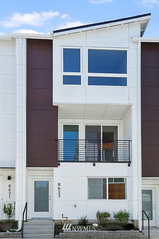a front view of a house with large windows