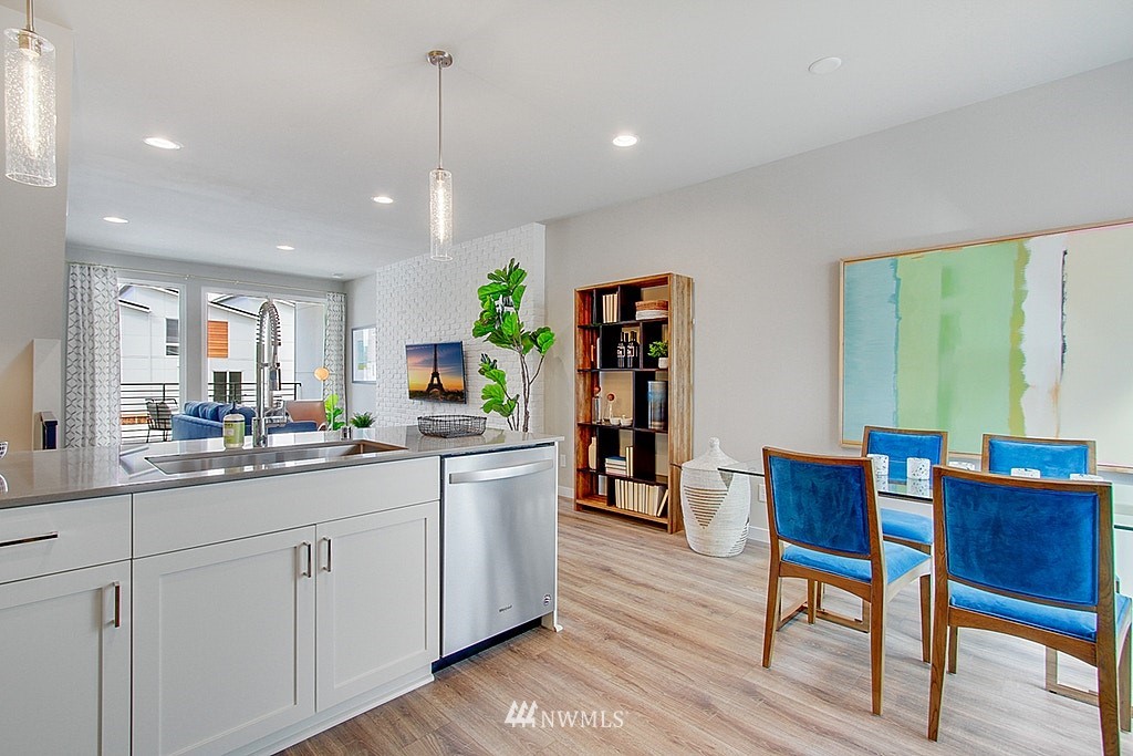 8554 22nd Place Northeast Seattle, WA 98115 - Photo 13 of 25 a kitchen with white cabinets and wooden floors