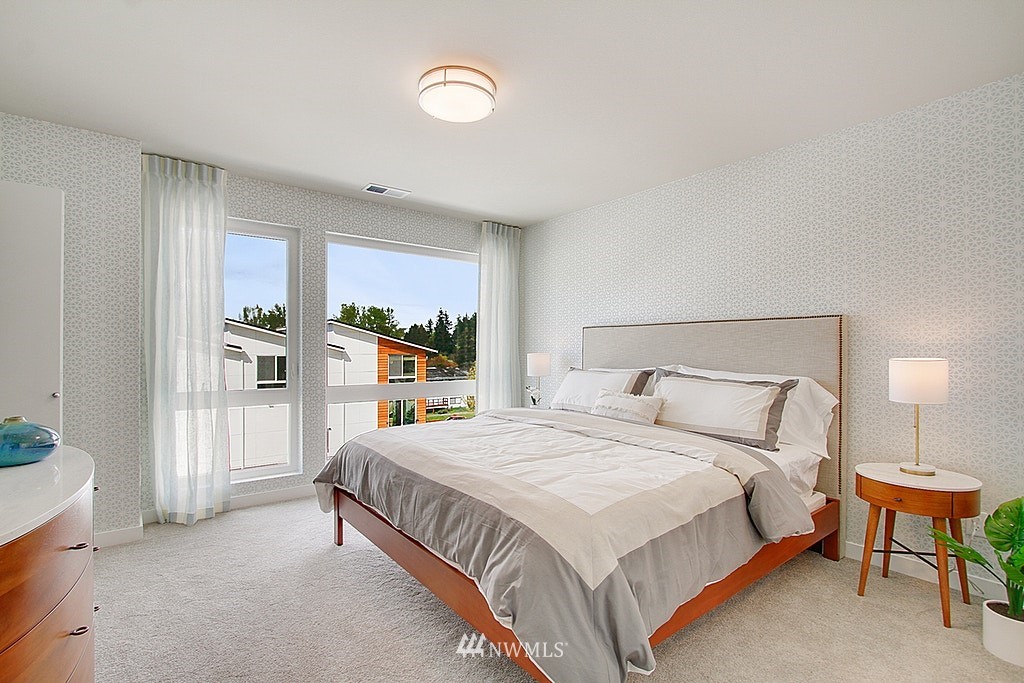 8554 22nd Place Northeast Seattle, WA 98115 - Photo 14 of 25 a bedroom with a large bed and a night stand
