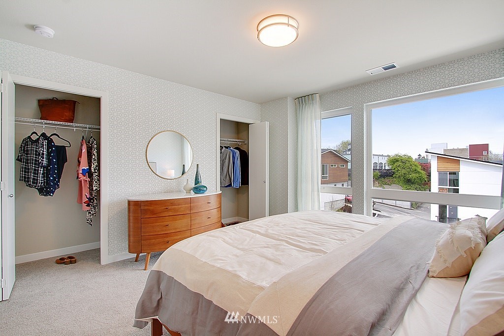 8554 22nd Place Northeast Seattle, WA 98115 - Photo 15 of 25 a bedroom with a large bed and a large mirror