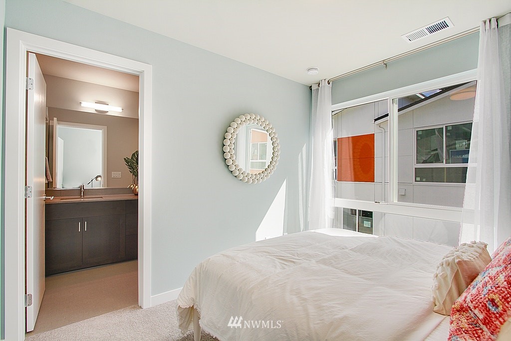 8554 22nd Place Northeast Seattle, WA 98115 - Photo 20 of 25 a bedroom with a bed and a mirror