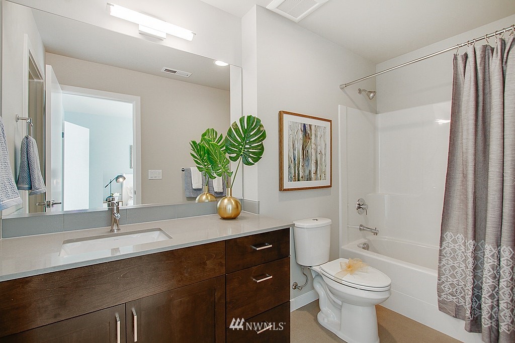 8554 22nd Place Northeast Seattle, WA 98115 - Photo 21 of 25 a bathroom with a granite countertop toilet sink and mirror