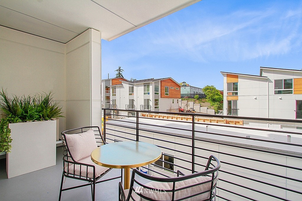 8554 22nd Place Northeast Seattle, WA 98115 - Photo 7 of 25 a balcony with a table and chairs