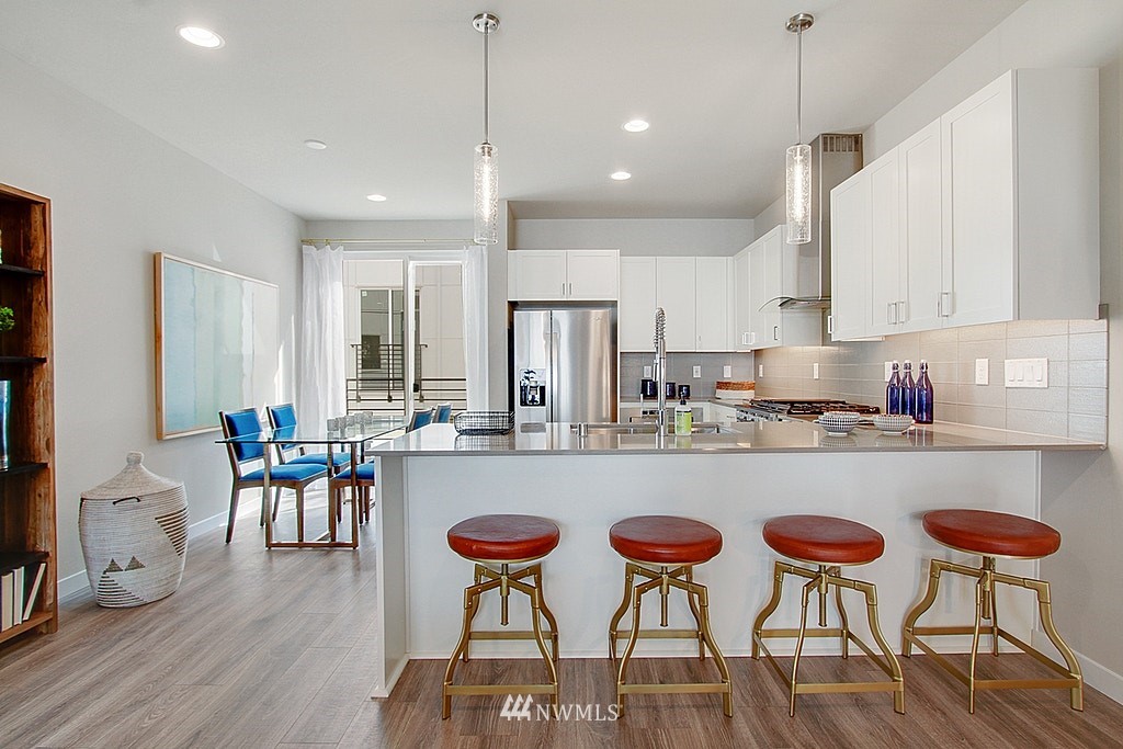 8554 22nd Place Northeast Seattle, WA 98115 - Photo 10 of 25 a large kitchen with a table and chairs