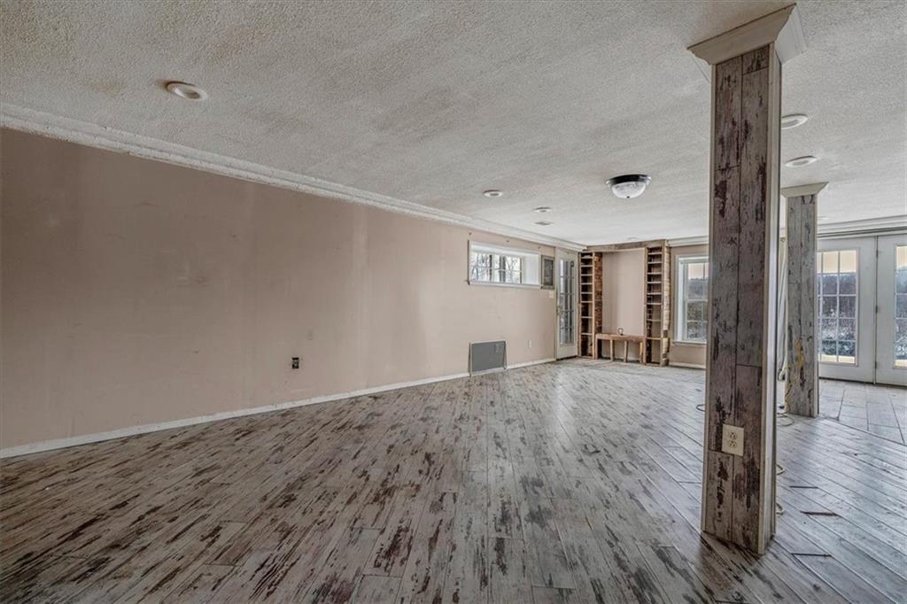 836 Saxonburg Road Butler, PA 16002 - Photo 11 of 49 an empty room with wooden floor and windows
