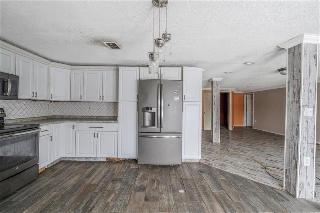 836 Saxonburg Road Butler, PA 16002 - Photo 6 of 49 a kitchen with granite countertop a refrigerator and a stove top oven