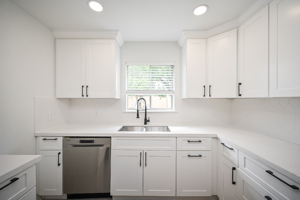 11027 Maize Lane Houston, TX 77041 - Photo 11 of 32 a kitchen with white cabinets and white appliances