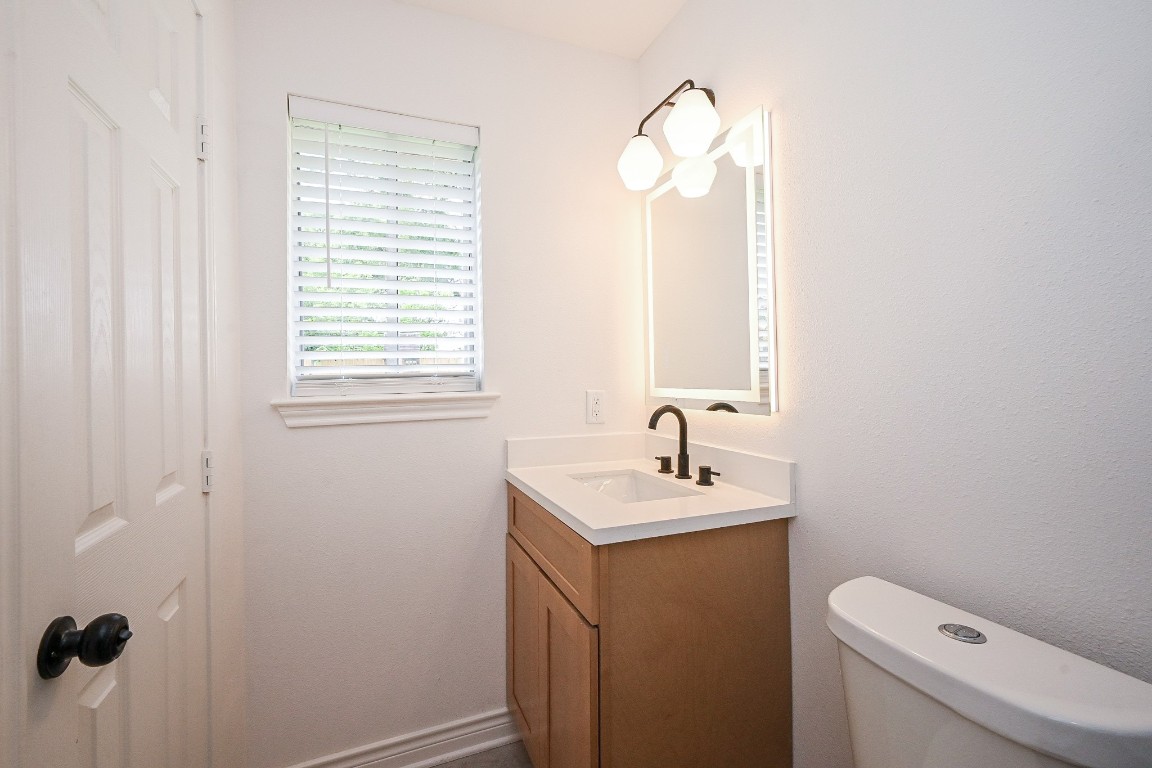 11027 Maize Lane Houston, TX 77041 - Photo 16 of 32 a bathroom with a sink a toilet and a mirror