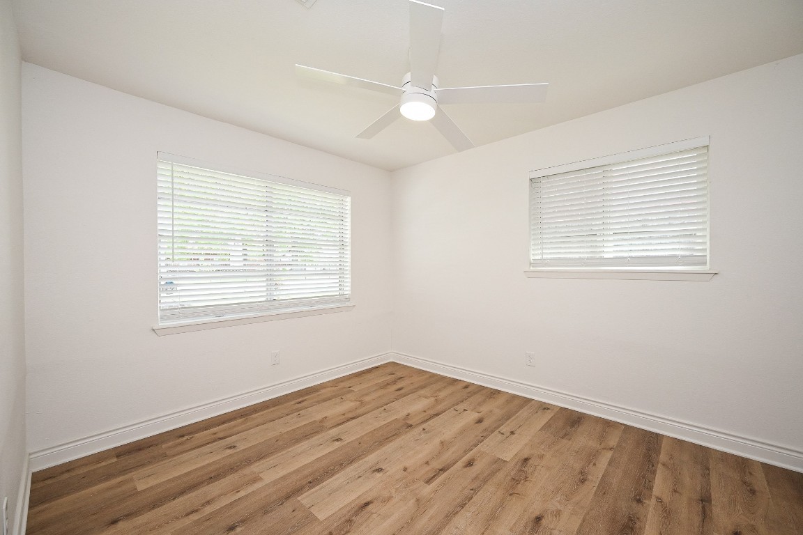 11027 Maize Lane Houston, TX 77041 - Photo 18 of 32 a view of an empty room with wooden floor and a window