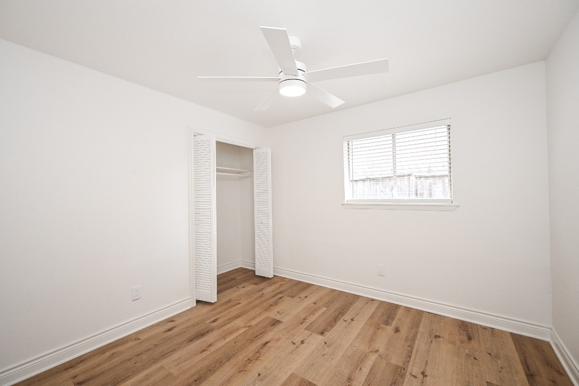 11027 Maize Lane Houston, TX 77041 - Photo 20 of 32 an empty room with wooden floor fan and windows